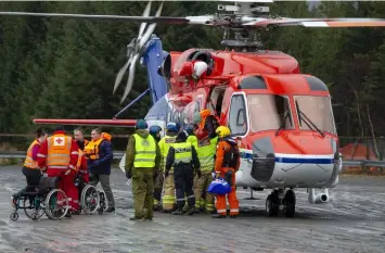  ??  ?? Passengers are helped from a rescue helicopter in Fraena, Norway, Sunday March 24, 2019, after being rescued from the Viking Sky cruise ship. Rescue workers are evacuating more passengers from a cruise ship that had engine problems in bad weather off Norway's western coast while authoritie­s prepare to tow the vessel to a nearby port. (Svein Ove Ekornesvag/NTB Scanpix via AP)