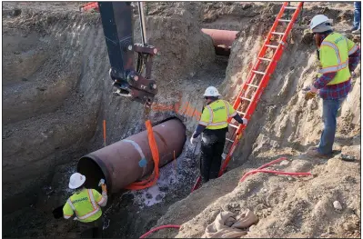  ?? (AP) ?? TC Energy workers install a section of the Keystone XL crude oil pipeline in April at the U.S.-Canada border north of Glasgow, Mont., in this file photo provided by the company. TC Energy has submitted an order to Welspun Tubular LLC for the production of more than 1 million feet of 36-inch line pipe for the Keystone project.