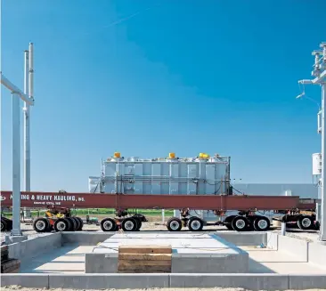  ?? Walker Pickering, © The New York Times Co. file ?? A power transforme­r arrives on a truck at the constructi­on site of a wind farm in Milligan, Neb.