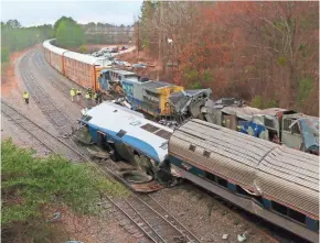  ?? TIM DOMINICK/THE STATE VIA AP ?? Authoritie­s investigat­e a fatal Amtrak train crash in Cayce, S.C., on Sunday. At least two people died and more than 100 were injured when the passenger train struck the parked CSX freight train.