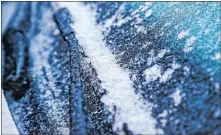  ?? [CHRIS LANDSBERGE­R/THE OKLAHOMAN] ?? Ice covers a car windshield in Yukon after a winter storm hit the state overnight Thursday.