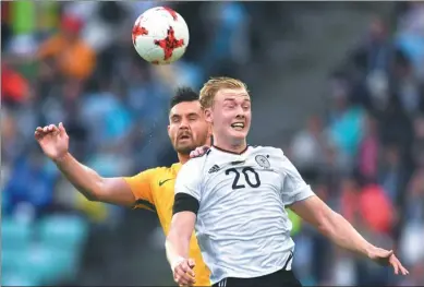  ?? MARTIN MEISSNER / AP ?? Germany’s Julian Brandt (right) and Australia’s Bailey Wright go up for a header during their Confederat­ions Cup, Group B match at Fisht Stadium in Sochi, Russia, on Monday. Germany weathered the Socceroos’ second-half storm to open its campaign with a...