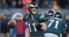  ?? THE ASSOCIATED PRESS FILE ?? Carson Wentz, seen here passing against the Seattle Seahawks during a wildcard playoff loss last Jan. 5, hasn’t gone into a huddle with his team since that game. Theoretica­lly, they could huddle again in a minicamp in late June when the coronaviru­s restrictio­ns will have been eased in the Commonweal­th.