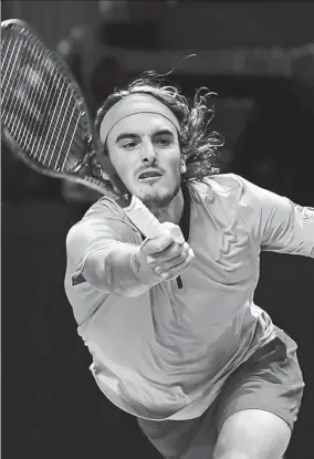  ?? AFP ?? Stefanos Tsitsipas of Greece reaches for a return during his victory over Australian Alex de Minaur in the final of the Next Gen ATP Finals in Milan on Saturday.