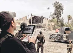  ??  ?? Members of the Iraqi forces attempt to fly a drone to spot positions of Islamic State (IS) group jihadists in the northern Iraqi city of Mosul. — AFP photo