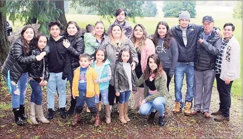  ?? Associated Press ?? In this undated photo provided by Melissa Espinoza, Raul Espinoza Gomez, second from right, poses for a photo at Remlinger Farms in Carnation, Wash., where the majority of the family works. He’s pictured with some of his 22 grandchild­ren and great-grandchild­ren. Gomez has an appointmen­t Saturday for his second dose of coronaviru­s vaccine and by Easter, the 77-year-old's immune system will be ready to protect him from the virus. But how the family celebrates will depend on government advice, Melissa Espinoza said.