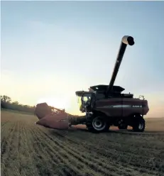  ?? TOBAN DYCK/FINANCIAL POST ?? A combine sits on a wheat field shortly after having dumped its load onto a grain truck. Four years ago, Toban Dyck and his wife Jamie returned to Manitoba to work on his family’s farm. Now, Toban owns his own land and he and Jamie recently bought the...