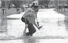  ?? WIN MCNAMEE, GETTY IMAGES ?? Residents return to their homes in Houston as floodwater­s begin to retreat. The city will get a chance to dry out a little.