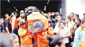  ?? Reuters photo ?? Rescuers carry the coffin of Juan Fernando Galindo, member of the National Coordinato­r for Disasters Reduction (CONRED), during his funeral in Alotenango, Guatemala. According to CONRED executive director Sergio Cabanas, Galindo died while attempting...