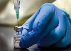  ?? CP PHOTO NATHAN DENETTE ?? A health-care worker prepares a dose of the Pfizer-BioNTech COVID-19 vaccine at a UHN COVID-19 vaccine clinic in Toronto on Thursday.