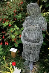  ??  ?? Above right: A chicken wire statue celebrates pregnancy. By Leo Cappel Above: Flowers are made of the white clay produced in the area. By Kim Logue.