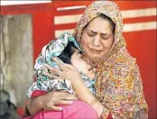  ?? MUKHTAR KHAN/AP ?? Kousain Ajaz, whose braid was chopped off by unidentifi­ed assailants, is comforted by her mother inside their home.