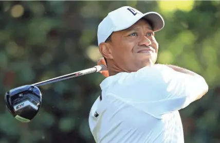  ??  ?? Tiger Woods plays his shot from the 11th tee during a practice round for the Masters on Tuesday in Augusta, Ga. Woods hasn’t won on the PGA Tour in 41⁄2 years.