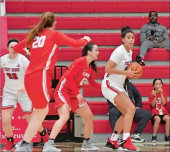  ?? PHOTO COURTESY OF STONY BROOK ATHLETICS ?? Stony Brook’s India Pagan, right, the former New London High School great, looks to make a pass from the post during a recent game against Cornell. Pagan had 12 points and nine rebounds on Tuesday night as Stony Brook won its seventh straight with a 73-58 road victory over Sacred Heart in Fairfield.