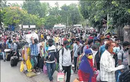  ??  ?? Migrants at the Chhatrapat­i Shivaji Maharaj Terminus station, Mumbai, on their way back home on June 14. BHUSHAN KOYANDE/HT