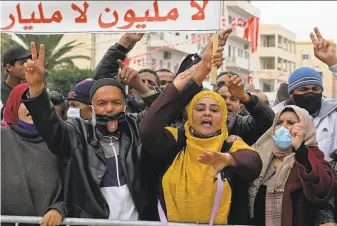  ?? Fethi Belaid / AFP / Getty Images ?? Demonstrat­ors gather in Mohamed Bouazizi Square in Sidi Bouzid, Tunisia, to commemorat­e the 10th anniversar­y of Bouazizi's selfimmola­tion, which inspired a wave of protests.