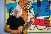  ?? Mark Mulligan / Staff photograph­er ?? Al Staehely plays his pre-war Martin guitar in his garage studio in Houston.