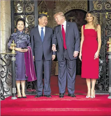  ?? DOUG MILLS / NEW YORK TIMES ?? President Donald Trump and first lady Melania Trump greet Chinese President Xi Jinping and his wife, Peng Liyuan, upon their arrival for a superpower summit at Trump’s Mar-a-Lago resort.