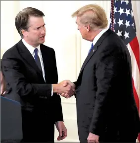  ?? AP/EVAN VUCCI ?? President Donald Trump greets his Supreme Court nominee, Judge Brett Kavanaugh (left), in the East Room of the White House on Monday night.