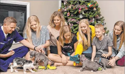  ?? Elizabeth Page Brumley Las Vegas Review-journal @Elipagepho­to ?? The Neibaur family plays Wednesday with their puppies and foster-to-adopt kitten at their home in Henderson.