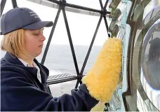  ??  ?? Bright future: Cleaning the lighthouse before a tour