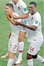  ?? AP ?? Cristiano Ronaldo (left) celebrates with his teammates after scoring Portugal’s goal against Morocco during their Group ‘B’ match at the Luzhniki Stadium in Moscow on Wednesday. —