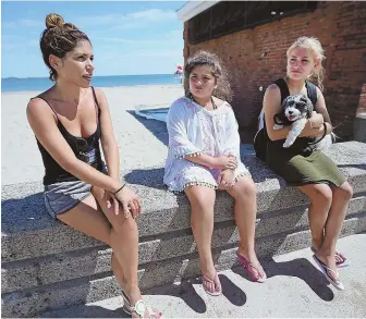  ?? STAFF PHOTOS BY NANCY LANE ?? ‘UNFORTUNAT­E’: Nadia Marchio, left, with nieces Isiana and Marialda Romei, says Revere Beach should be ‘cleaned up’ after a reported bathhouse sex assault, top.