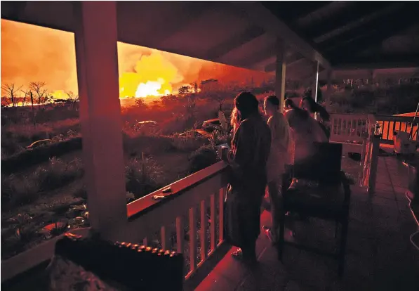  ??  ?? Residents who returned to check their homes in the exclusion zone of Puna district near Mount Kilauea are transfixed by a bubbling cauldron of liquid lava at Fissure 17. Some 50 properties have been destroyed in the area