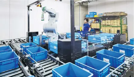  ?? KO SASAKI / THE NEW YORK TIMES ?? A robot at Mujin, a company that produces devices that control industrial robots, in Tokyo. Precision parts and behind-the-scenes technology could play a major role in Japan’s effort to shake itself out of its slow-growth doldrums.