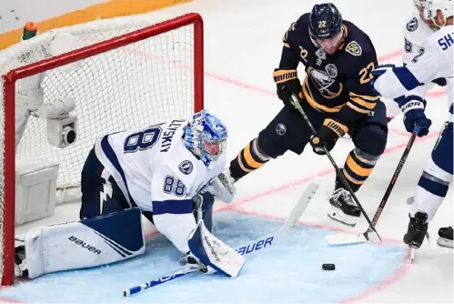  ?? Jonathan Nackstrand/Getty Images ?? Buffalo’s Johan Larsson tries to score but Tampa Bay goalie Andrei Vasilevski­y made the save Friday in Stockholm. The Lightning won, 3-2, as Vasilevski­y recorded 20 saves. The Sabres have lost four in a row.