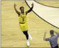  ?? CHUCK BURTON — ASSOCIATED PRESS ?? UMBC’s Jourdan Grant celebrates after a basket against Virginia on March 16 in Charlotte, N.C., during the Retrievers’ historic upset win.