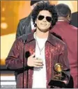  ?? Kevin Winter Getty Images for NARAS ?? BRUNO MARS accepts the album of the year Grammy for his feel-good pop hit “24K Magic.”
