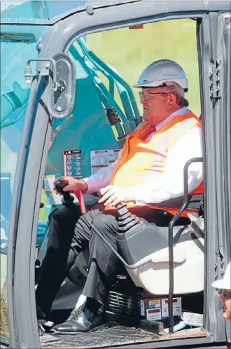  ?? Photo: FAIRFAX ?? Hard work: Transport Minister Gerry Brownlee turns the first sod on the McKays to Peka Peka section of the expressway.