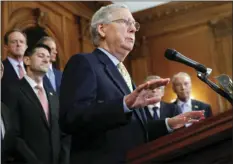  ??  ?? Senate Majority Leader Mitch McConnell, R-Ky., (center), with Speaker of the House Paul Ryan, R-Wis., (left), and other GOP members as they talk about the Republican­s’ proposed rewrite of the tax code for individual­s and corporatio­ns, at the Capitol in...