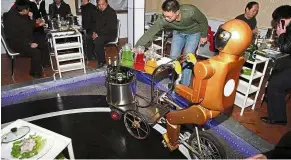  ?? — AP ?? Bot service: A customer collecting a drink from a robot waiter in a restaurant in Jinan in eastern China’s Shandong province.
