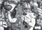  ?? ASSOCIATED PRESS FILE PHOTO ?? Oakland Raiders quarterbac­k Derek Carr throws during the Dec. 10 game against the Kansas City Chiefs in Kansas City, Mo.