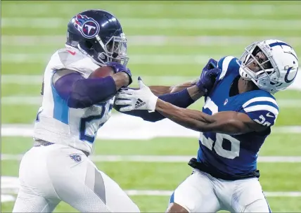  ?? AJ MAST/AP ?? Tennessee Titans running back Derrick Henry (22) tries to get past Indianapol­is Colts outside linebacker Darius Leonard. The Titans defeated the Indianapol­is Colts on Sunday to take the lead in the AFC South.