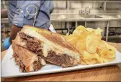  ??  ?? A brisket grilled cheese, with braised beef, barbecue and a side of kettle chips from Hot Press Express portable carts in sections 104, 226 and 307.