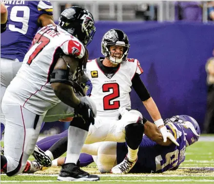  ?? STEPHEN MATUREN / GETTY IMAGES ?? The Falcons’ Matt Ryan grimaces as he is sacked by Minnesota’s Everson Griffen in the fourth quarter on Sunday in Minneapoli­s. “To come out and perform the way we did was disturbing,” coach Dan Quinn said after the 28-12 loss.