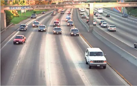  ?? ASSOCIATED PRESS ?? A white Ford Bronco, driven by Al Cowlings and carrying O.J. Simpson, is trailed by police cars as it travels on a southern California freeway on June 17, 1994, in Los Angeles.