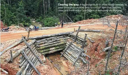  ??  ?? A log bridge built to allow heavy vehicles to pass through is situated next to a small dam that supplies clean and fresh water to villagers of Kampung Ulu Mahang. Clearing the way: