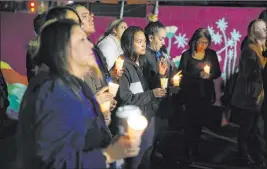  ?? Erik Verduzco Las Vegas Review-journal @Erik_verduzco ?? People attend a candleligh­t vigil Thursday to memorializ­e the homeless people in Clark County who died in the past year. This year 109 names were recited.
