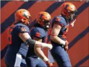  ?? JIM YOUNG — THE ASSOCIATED PRESS ?? Mike Epstein of Illinois, right, celebrates his touchdown against South Florida with teammates Doug Kramer, left, and Austin Roberts last Saturday in Chicago.