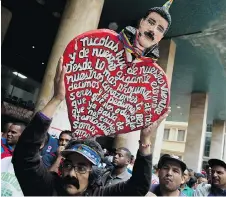  ?? RICARDO MAZALAN/THE ASSOCIATED PRESS ?? A man proclaims support Tuesday in Caracas for Nicolas Maduro, who returned to power on the weekend in the Venezuelan presidenti­al election. U.S. Gulf Coast refineries could soon process more Canadian crude as Venezuelan production declines further...