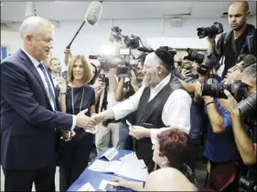  ??  ?? Blue and White party leader Benny Gantz and his wife Revital vote in Rosh Haayin, Israel, on Tuesday. AP PHOTO/SEBASTIAN SCHEINER