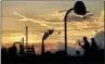  ?? DAVID GOLDMAN — THE ASSOCIATED PRESS ?? An oil refinery stands in the background as children play on a basketball court in Port Arthur, Texas, Wednesday, Sept. 27, 2017.