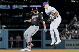  ?? Robert Gauthier Los Angeles Times ?? SECOND BASEMAN Gavin Lux takes the throw as Washington’s Ryan Zimmerman reaches second on a double to lead off the eighth inning.