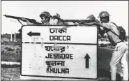  ?? (File Photo/AP) ?? Indian troops stand guard Dec. 8, 1971, at a road crossing to Dacca after capturing Jessore town, East Pakistan.