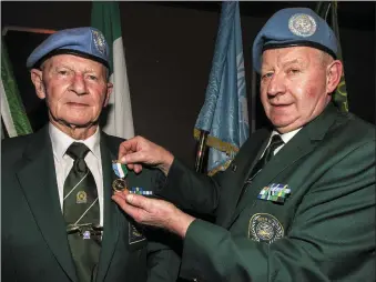  ?? Photo by John Reidy (right) ?? John O’Mahony from Scartaglin was badly wounded in the Battle of At Tiri in South Lebanon in 1980. he is pinning a service medal on his UNIVA Post 2 colleague Matt Murphy at a ceremony in Castleisla­nd.