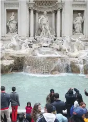  ?? JEFF J. MITCHELL / GETTY IMAGES ?? Millions of dollars in loose change, thrown every year into Rome’s Trevi Fountain by tourists, will now go to the city instead of Catholic Church charities.